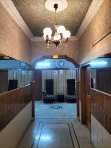 a hallway in a building with a chandelier at Jinnah Airport Hotel in Karachi