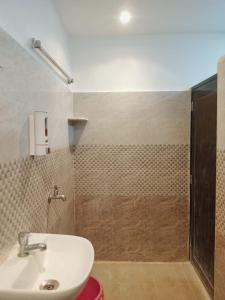 a bathroom with a sink and a shower at CHINTA HARAN REST HOUSE in Deoghar