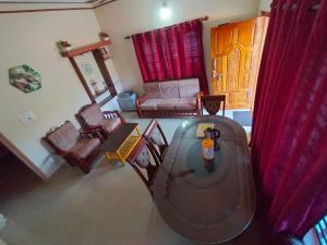 an aerial view of a living room with a couch and chairs at Snowdrop inn coorg in Madikeri