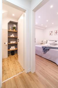 a bedroom with a bed and a wooden floor at Kuća za odmor INK in Nerežišće