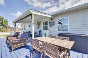 a patio with a wooden table and chairs on a house at Cottage with St Andrews Bay Views, Deck and Porch! in Panama City