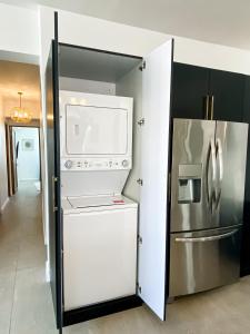 a kitchen with a refrigerator and a microwave at N1 Condos in San Juan