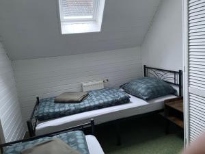 two beds sitting in a room with a window at Ferienhaus Weniger in Bad Saarow