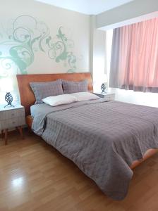 a bedroom with a large bed and a window at Miraflores View in Lima