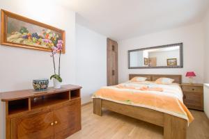 a bedroom with a bed and a mirror on the wall at Residence in Mariánské Lázně