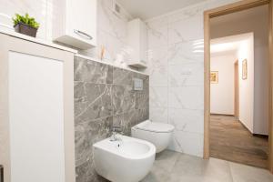 a bathroom with a white toilet and a sink at Residence in Mariánské Lázně +19 photos