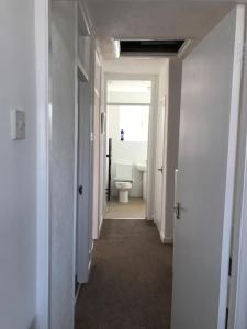 a hallway of a bathroom with a toilet in it at Diana House in Foleshill
