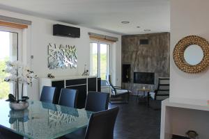a dining room with a table and chairs and a living room at Exclusiva casa con piscina en Gondomar in Gondomar