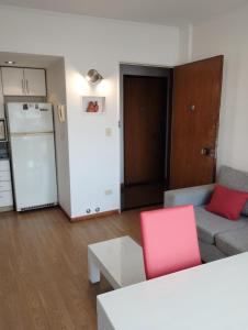 a living room with a couch and a white refrigerator at Departamento Zona Puerto De Olivos in Olivos