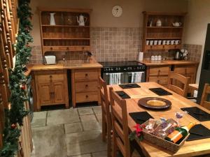 a kitchen with a table and a christmas tree at Masonic House, Alston in Alston