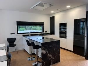 a kitchen with a black counter and black appliances at Casa Leiras in O Grove