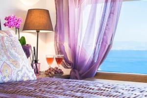 a bedroom with a bed and a window with wine glasses at Villa Uliana Kassandra Greece in Afitos