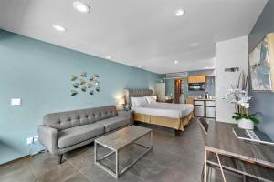 a living room with a couch and a bed at 14 West Boutique Hotel in Laguna Beach