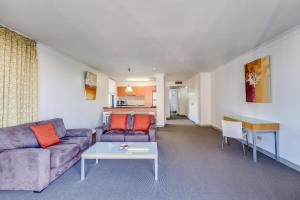 a living room with a couch and a table at Hillcrest Apartment Hotel (formerly Central Hillcrest Apartments) in Brisbane