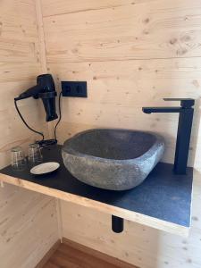 a bathroom with a stone sink on a counter at Ferienresort Edersee GmbH in Hemfurth-Edersee
