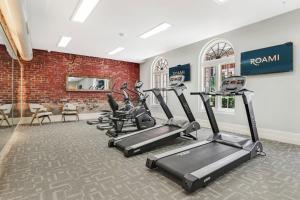 a fitness room with treadmills and cardio equipment at Roami at Factors Row in New Orleans