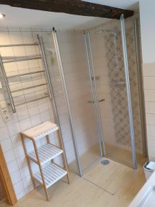 a shower in a bathroom with a wooden stool at Ferienhaus Bildhauer Thiele in Ottendorf +27 photos