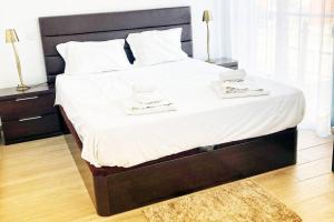 En eller flere senge i et værelse på Vivenda Espaçosa e Luminosa
