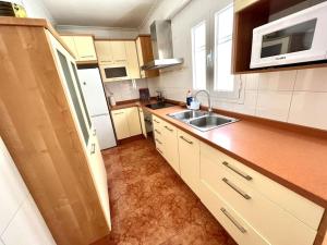 a small kitchen with a sink and a microwave at stylish apartment 308 in Almería