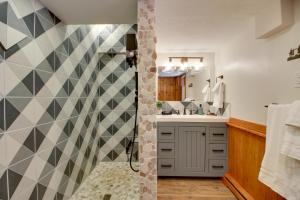a bathroom with a checkered wall at Away at Moose Bay Breezy Point Gem with Game Room in Breezy Point +31 photos