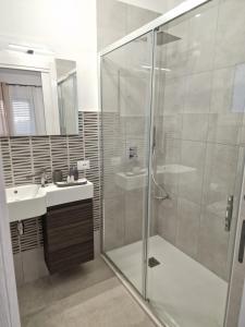 ein Bad mit einer Glasdusche und einem Waschbecken in der Unterkunft Villa Eden, Bed and Breakfast in Cinisi