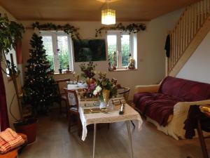 a living room with a christmas tree and a couch at Apple tree House in Saltdean