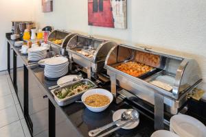 a buffet line of food in a restaurant at Hotel Astor Tijuana in Tijuana