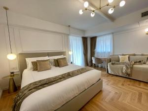 a bedroom with a large bed and a dining room at Bellagio Luxury Suites Apartments in Bellagio