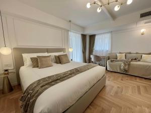 a bedroom with a large bed and a dining room at Bellagio Luxury Suites Apartments in Bellagio