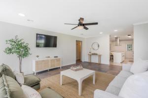 a living room with a couch and a ceiling fan at Updated & centrally located 3 Bed in Lafayette