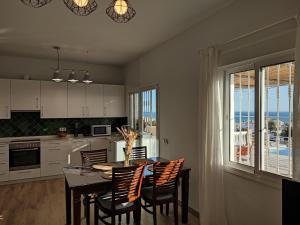a kitchen with a table and chairs and a dining room at Villa Delicia in Torrox