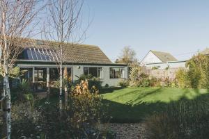 a house with a yard with a grass yard at Architect designed spacious five bed house by sea in Seasalter