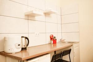 a kitchen with a counter with a toaster and a sink at Doba In Ua Studio Irpin Apartments in Irpin'