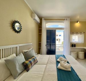 a bedroom with a white bed with towels on it at Albufeira Sunset With Pool by Homing in Albufeira +28 photos