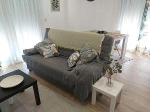a living room with a couch and a table at Casa en piedra (Stone House) in Porriño