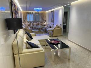 a living room with couches and a table at اقامة الاحلام in Nador