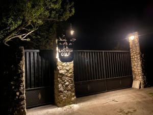 a sign on a fence with a gate at night at La Lagunilla Golf in Candeleda