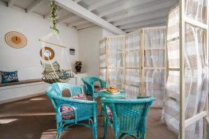 a dining room with blue chairs and a table at Le tre sirene in Porto Cesareo