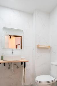 a bathroom with a sink and a mirror at Apt Boavista 3bdr Casa da música in Porto