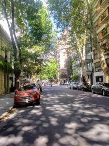 a red car parked on the side of a street at Recoleta 2 amb in Buenos Aires