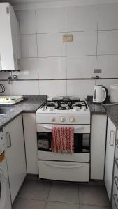 a white stove top oven in a kitchen at Recoleta 2 amb in Buenos Aires
