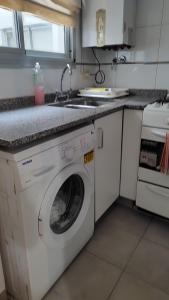 a kitchen with a washing machine and a sink at Recoleta 2 amb in Buenos Aires