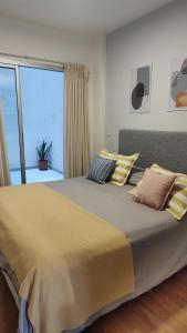 a large bed in a bedroom with a large window at Recoleta 2 amb in Buenos Aires +14 photos
