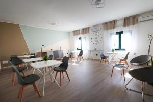 a large room with tables and chairs in a building at Il Sole Del Salento in Salve