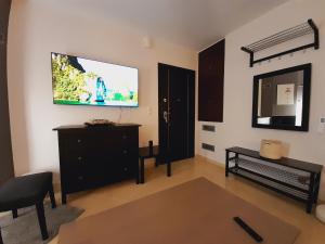 a living room with a flat screen tv on the wall at Beautiful house with great castle view! in Myrina