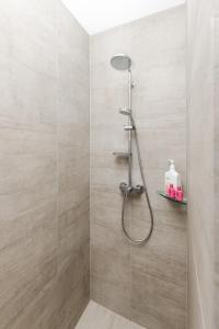 a shower with a shower head in a bathroom at Sweet Magnolia 1 or 2 BR Suite St Kilda Cambridge with Complimentary Continental Breakfast in Cambridge