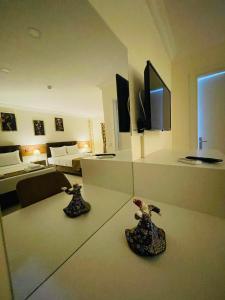 a living room with two vases on a table in a hotel room at Sirius Boutique Otel Pamukkale in Pamukkale