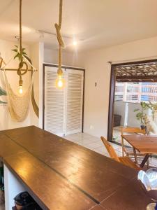 a kitchen with a table and a dining room at Casa Mar in Praia do Forte