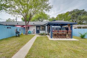 a house with a blue fence and a yard at San Antonio Vacation Rental about 7 Mi to River Walk! in San Antonio