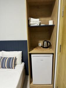 een kamer met een kleine koelkast naast een bed bij Enda Lara Hotel in Antalya